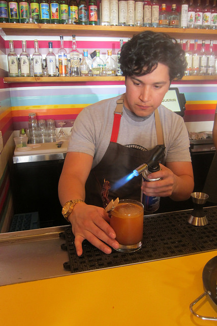 flaming the garnish for Mole Rojo